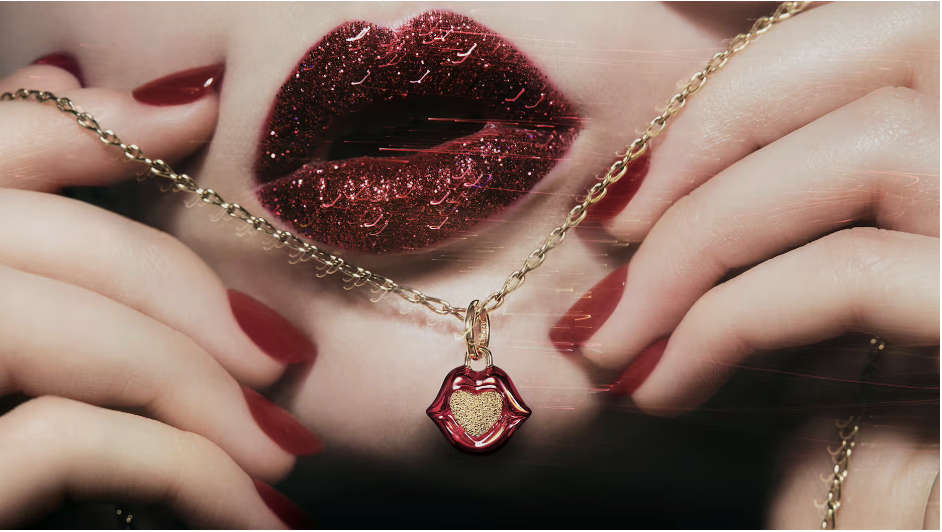 Glittering red lips behind a gold chain with an enamel lip-shaped charm from Pandora x Pat McGrath