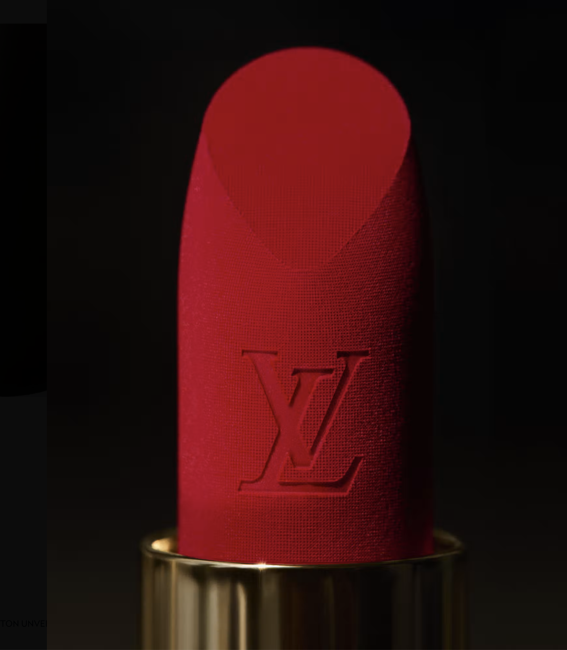 Close-up of a red La Beauté Louis Vuitton lipstick bullet engraved with LV