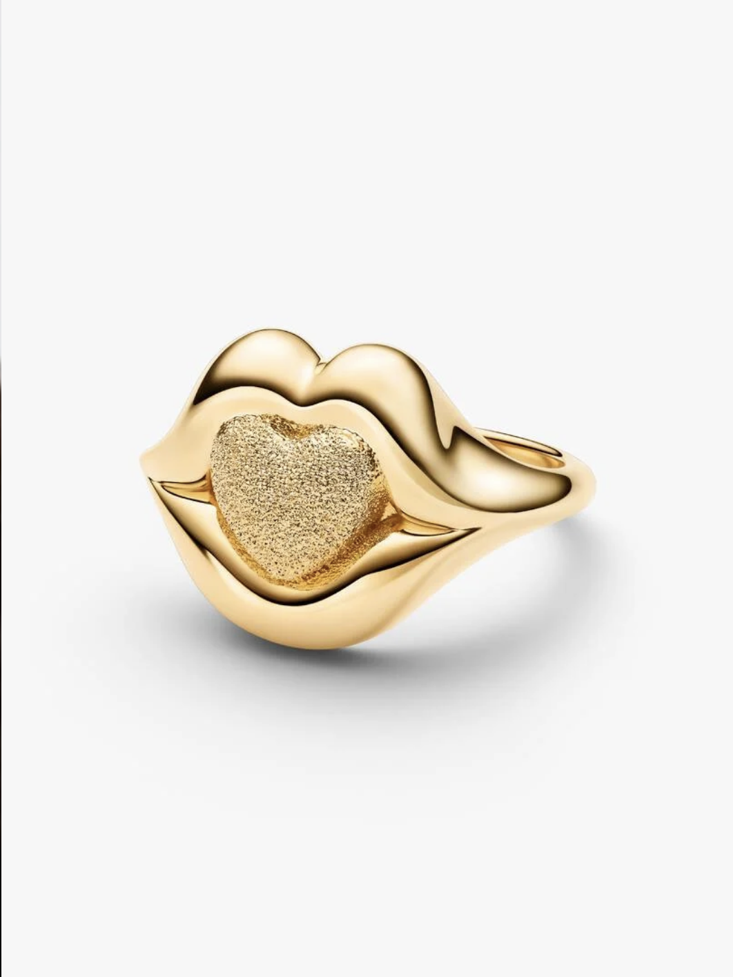 Gold lip-shaped statement ring with a textured heart